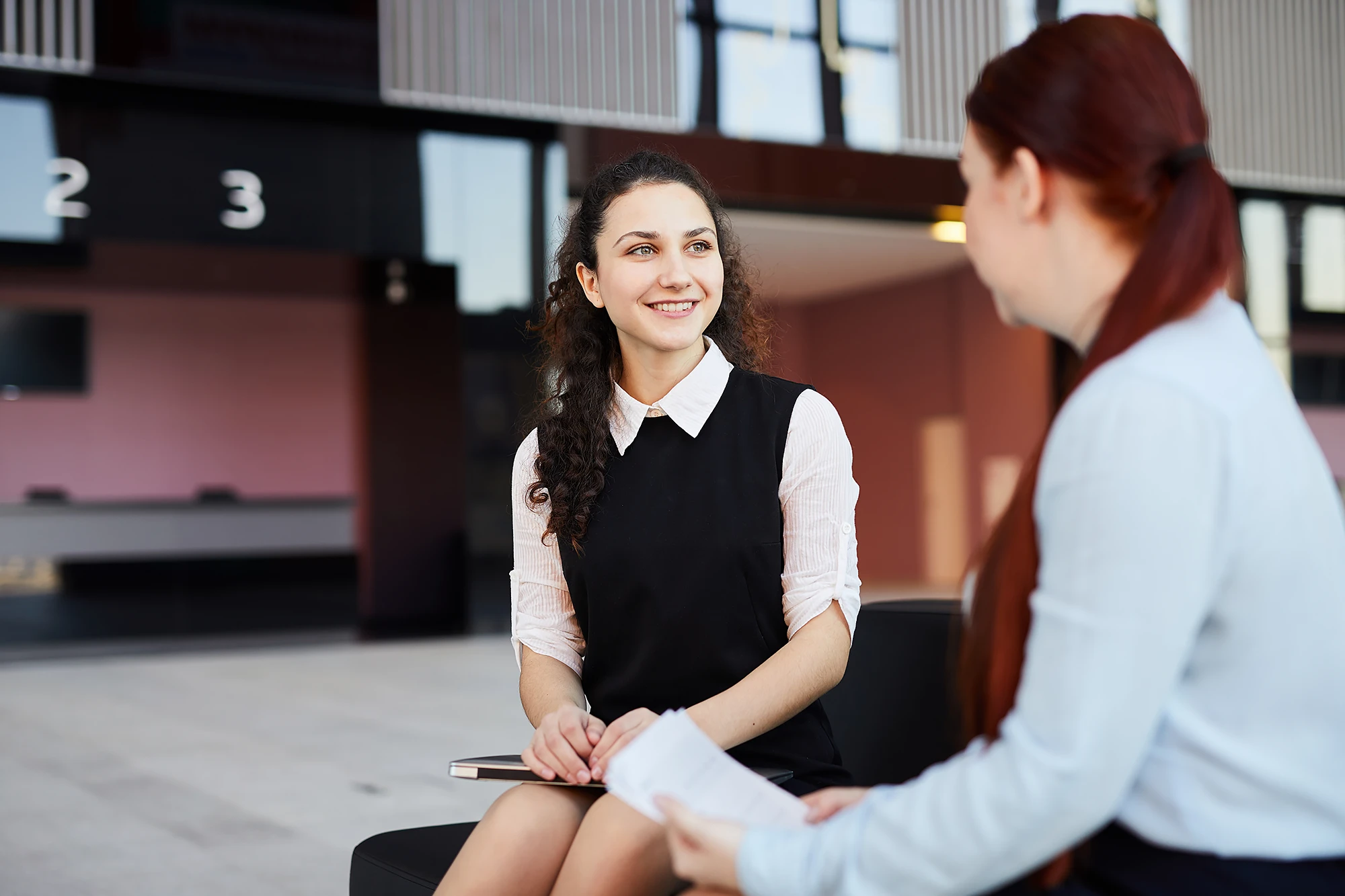 Employee Benefits A pair fist-pumping in an office